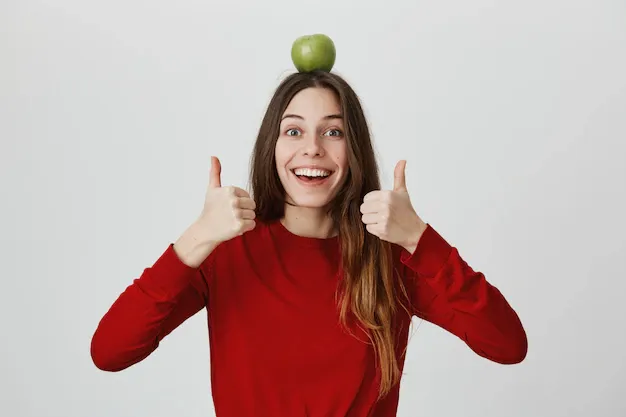 enthusiastic-smiling-girl-with-green-apple-head-showing-thumbs-up_176420-17364.webp