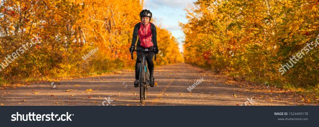 stock-photo-biking-cyclist-cycling-on-road-bike-in-autumn-nature-outdoor-park-asian-girl-cycling-enjoying-cold-1524499178.jpg