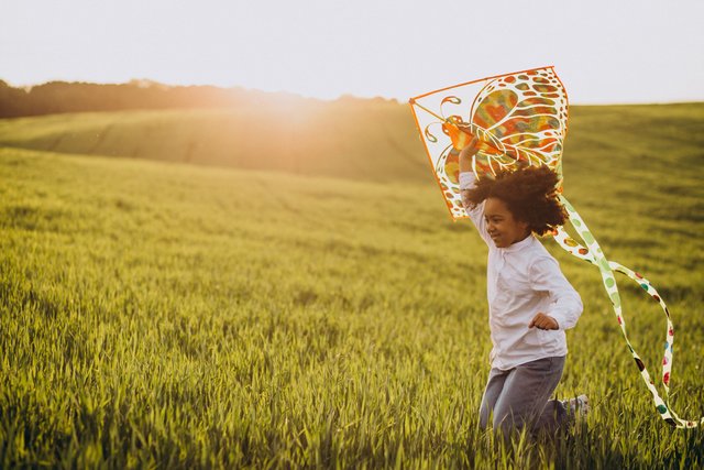 cute-african-baby-girl-field-sunset-playing-with-kite.jpg