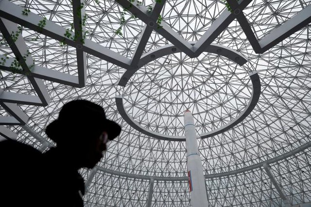 A man walks in front of a replica of a Unha-3 rocket displayed in Pyongyang April 17, 2017. REUTERS.Damir Sagolj.jpg