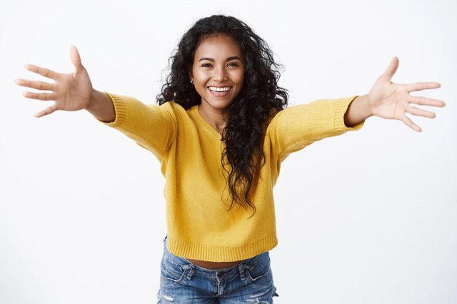 cheerful-friendly-looking-pretty-woman-yellow-sweater-spread-hands-warm-welcome-smiling-joyfully-wanna-hug-greeting-friend-cuddling_176420-37602.jpg