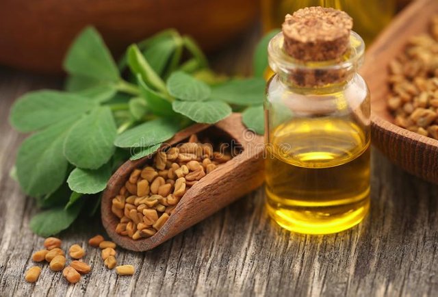 fenugreek-seeds-oil-bottle-wooden-background-147526594.jpg