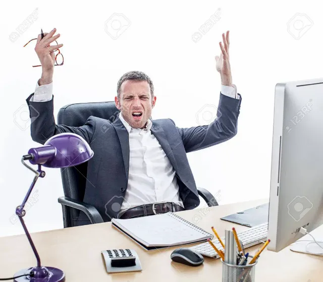 65969477-complaining-middle-aged-businessman-sitting-at-his-office-raising-annoyed-hands-for-exasperation-mis.webp
