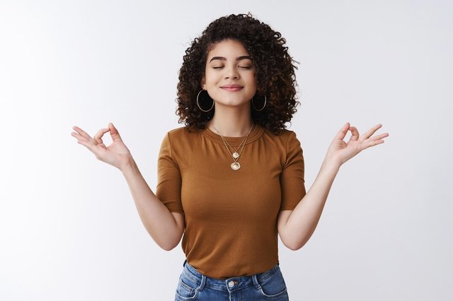 om-girl-feels-peace-patience-attractive-carefree-relaxed-happy-young-woman-curly-shirt-hairstyle-close-eyes-smiling-delighted-meditating-hands-sideways-nirvana-lotus-pose-breathing-practice-yoga_176420-34918.jpg