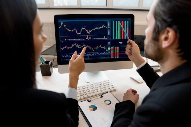 business-colleagues-cofounders-company-managers-stock-market-traders-sitting-desktop-front-computer-screen-analyze-dynamics-charts-discuss-strategy-predict-draw-up-report_754108-592.jpg