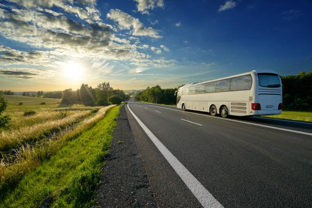 white-bus-traveling-on-the-asphalt-road-in-a-rural-landscape-at-picture-id879364174.jpeg