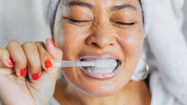 Female_Brushing_Teeth_1296x728-header-1296x728.jpg