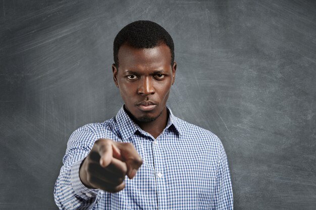 portrait-unhappy-african-boss-having-mad-expression-pointing-his-index-finger-looking-angrily-frowning-as-if-accusing-blaming-you-mistake-selective-focus-man-s-face_273609-1416.jpg