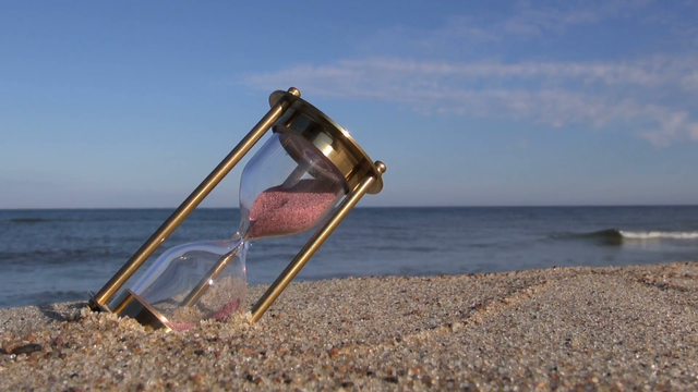 brass-ancient-hourglass-sandglass-clock-on-sea-beach-sand-summer-time-concept_nkmalykx__F0000.png