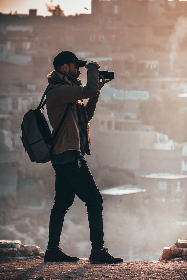 man-holding-black-dslr-camera-1540977.jpg