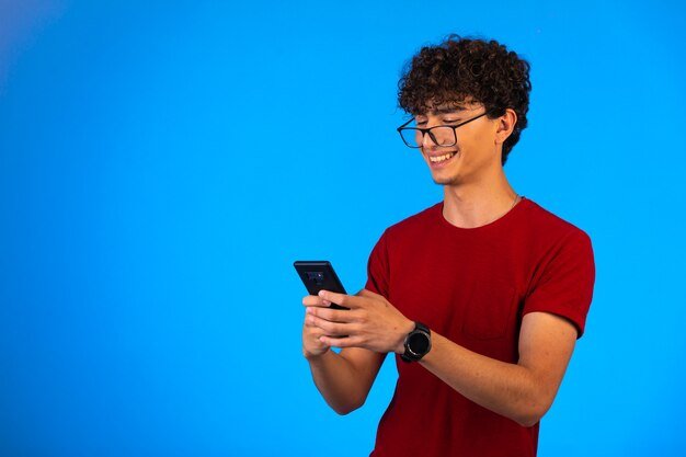 man-red-shirt-taking-selfie-smartphone-blue-laughing_114579-13491.jpg