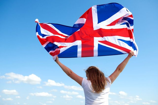 rear-view-young-woman-waving-british-flag1.jpg