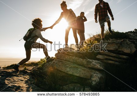 stock-photo-group-of-hikers-on-a-mountain-woman-helping-her-friend-to-climb-a-rock-young-people-on-mountain-578493865.jpg