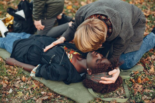 guys-help-woman-african-girl-is-lying-unconscious-providing-first-aid-park_1157-40367.jpg