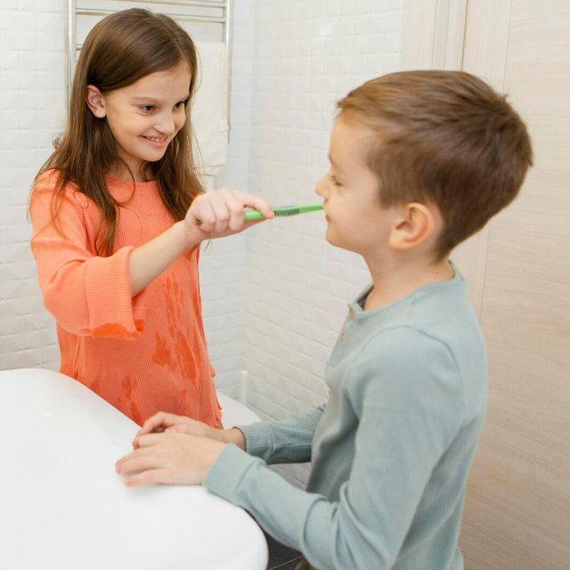 girl-helping-her-brother-wash-his-teeth_23-2148755294.jpg