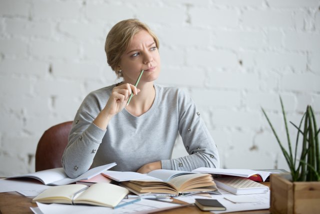 portrait-of-a-student-woman-at-the-desk-frowned.jpg