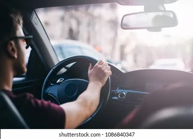 young-man-driving-business-car-260nw-1086840347.webp