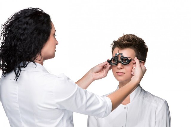 optometrist-holding-eye-test-glasses-giving-young-woman-examination_155003-7636.jpg