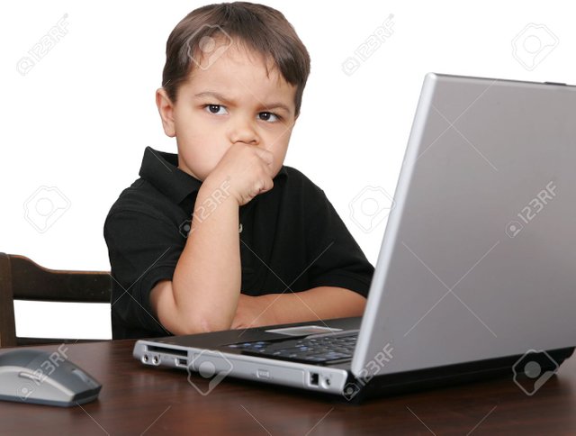 3111471-a-child-looking-unhappy-or-thinking-while-working-on-a-laptop-computer.jpg