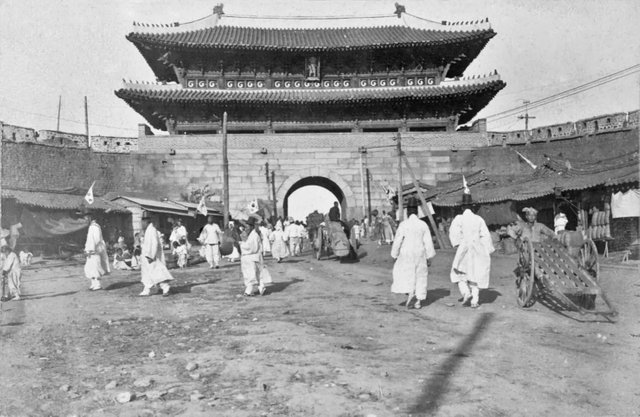 Namdaemun (Great South Gate in Seoul) is shown here with the tramtrails, which was instituted as a public transportion system in May 1899. ca. 1904.jpg