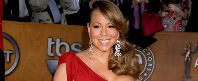 mariah-carey-sparkly-red-gown-while-sitting-in-pool.webp