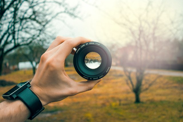 photography-of-person-holding-black-camera-lens-759960.jpg