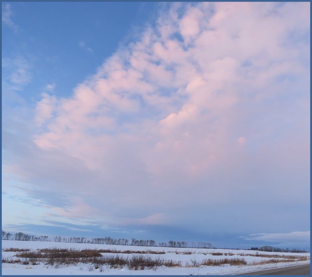 expansive sky sunset puffy pink clouds with some streaks.JPG