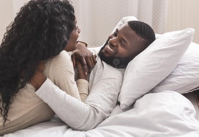 love-air-romantic-black-couple-bonding-bed-cuddling-smiling-to-each-other-closeup-portrait-romantic-black-165482599.jpg