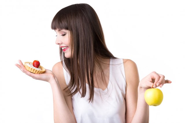 young-woman-choosing-cake-instead-apple.jpg
