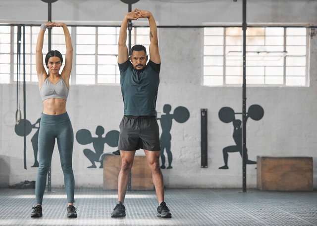 fitness-active-healthy-couple-stretching-exercising-training-together-inside-gym-two-young-fit-trainer-doing-full-body-workout-exercise-warmup-routine-day-time-with-copy-space_590464-68929.jpg