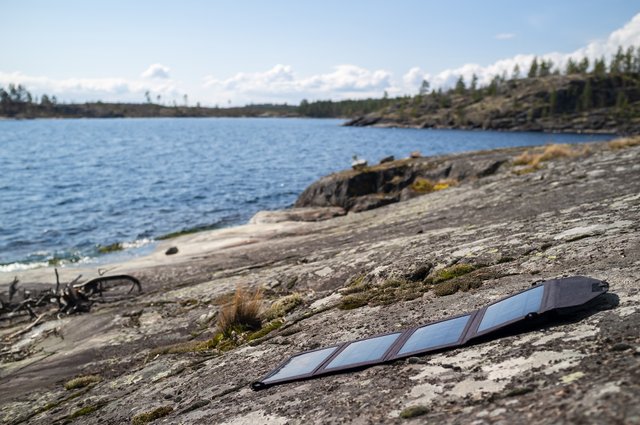 portable-solar-panels-lie-stone-shore-lake-accumulate-energy.jpg