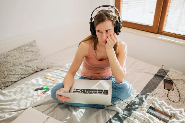 high-angle-woman-bed-with-laptop-bored-by-online-class_23-2148524623.jpg
