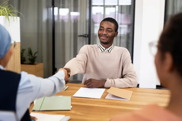 man-handshaking-his-employer-after-being-accepted-his-new-office-job_23-2149034565.webp