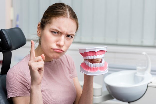 portrait-adult-woman-holding-toy-teeth_23-2148396227.jpg