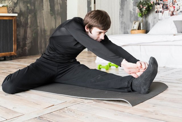 athletic-man-stretching-up-mat_23-2148241619.jpg