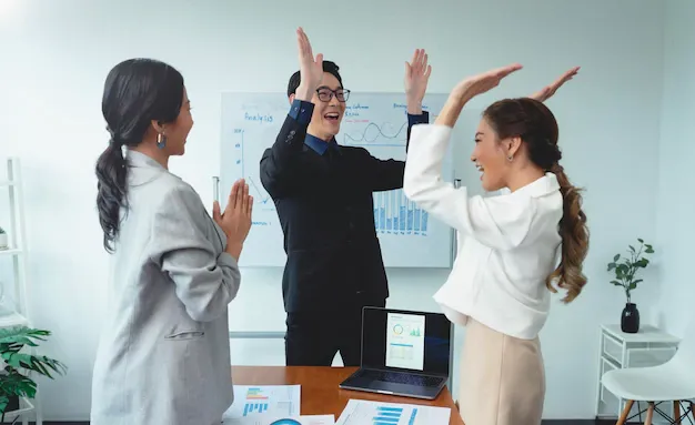 successful-business-team-is-clapping-their-hands-asian-businesspeople-celebration-during-meeting_74952-2995.webp