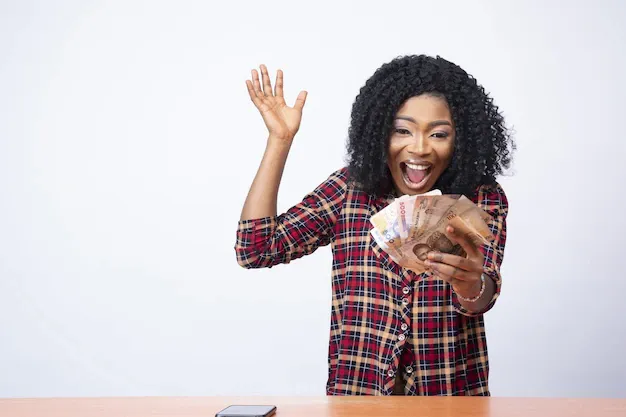 pretty-young-black-lady-holding-money-celebrating-front-white-background_181624-34742.webp