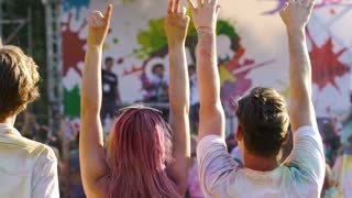 enthusiastic-youth-raising-hands-in-crowd-enjoying-holi-color-festival-outdoors_bied0pcfog_thumbnail-small01.jpg