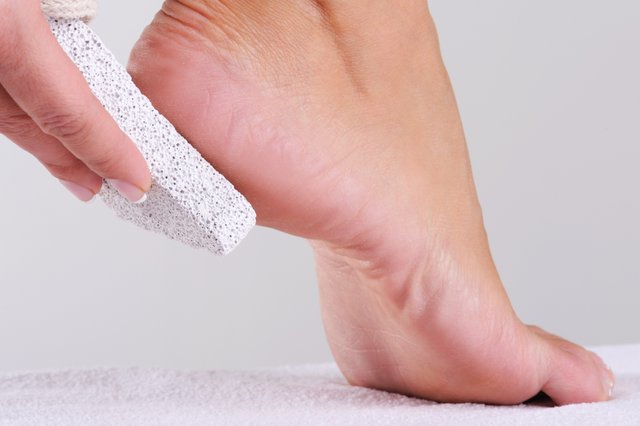 young-woman-scrubbing-her-foot-by-pumice-beauty-salon.jpg