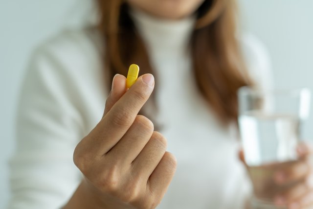 vecteezy_close-up-of-hand-s-woman-holding-a-dietary-supplement-or_17154802.jpg