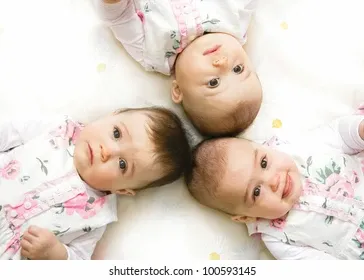 closeup-portrait-three-babies-lying-260nw-100593145.jpg