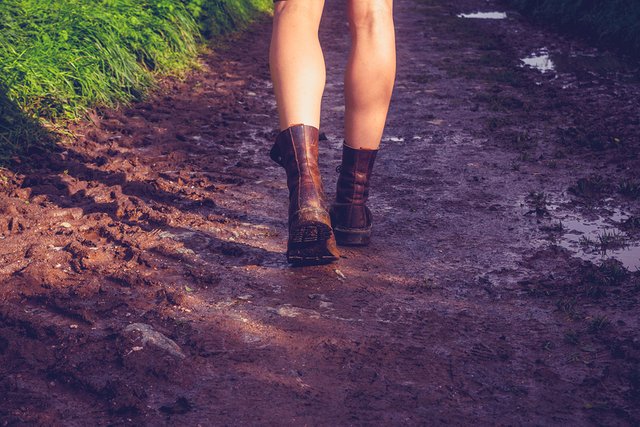 bigstock-Young-Woman-Walking-Along-Mudd-59129834.jpg