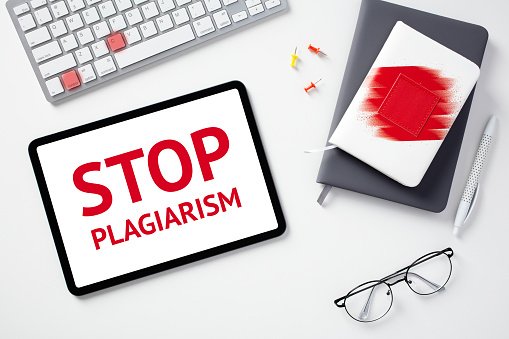 stop-plagiarism-concept-flat-lay-digital-tablet-with-text-stop-plagiarism-on-screen-keyboard.jpg