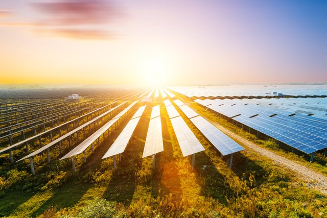 solar-panels-with-a-bright-sun-in-the-background.jpg