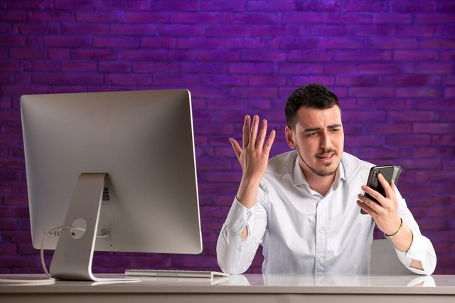 front-view-male-office-worker-sitting-his-working-place-talking_179666-25495.jpg