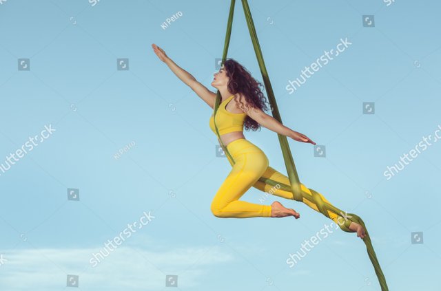 stock-photo-female-athlete-by-aerial-acrobatics-she-makes-a-performance-high-in-the-sky-712228486.jpg