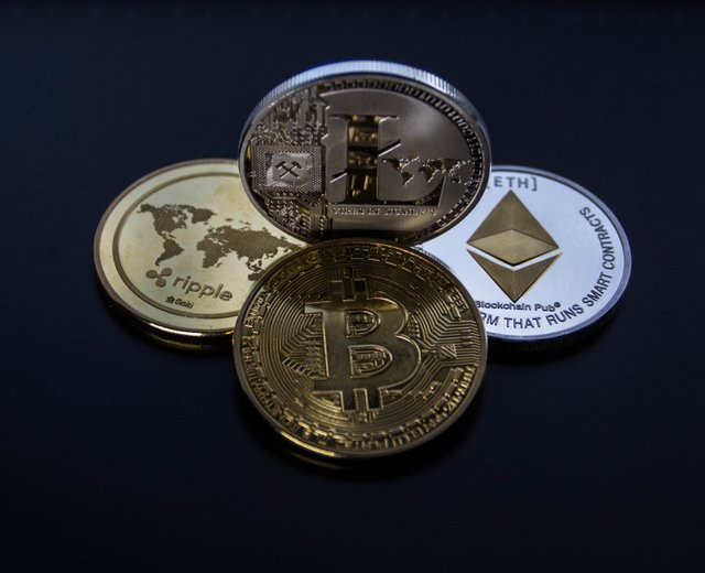 four-assorted-cryptocurrency-coins-843700.jpg