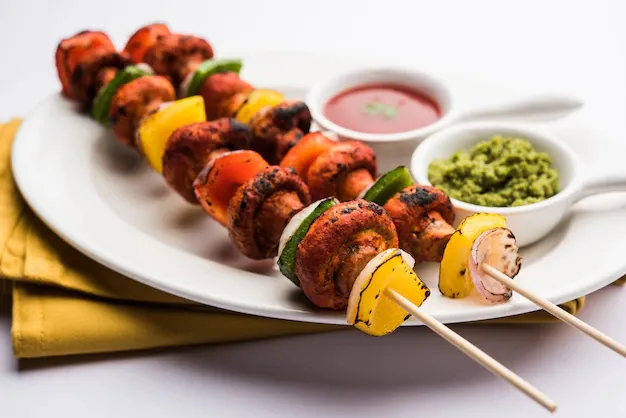 barbecue-tandoori-mushroom-tikka-served-plate-with-green-chutney-ketchup-selective-focus_466689-23810.webp