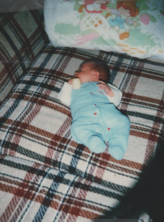 1985-03 Joey One Month Old Couch Strawberry Shortcake Pillow.png
