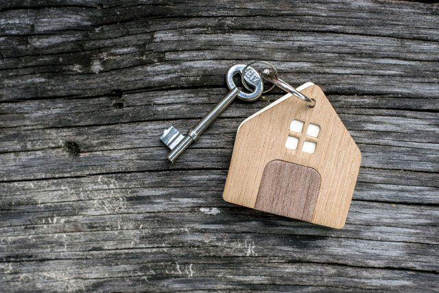 key-with-shaped-house-keychain-on-chain-on-wood-texture-background--idea--buying-a-house--renting--selling-real-estate--mortgage--1092254706-547600a8b647489b999d5b1299b27211.jpg